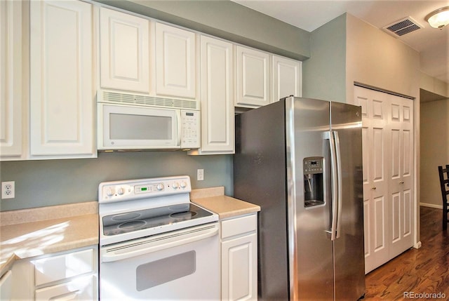 kitchen featuring white appliances, white cabinetry, and dark wood-type flooring