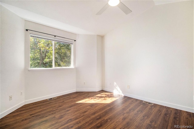 spare room with vaulted ceiling, ceiling fan, and dark wood-type flooring