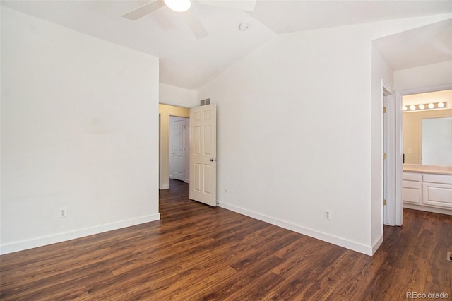 unfurnished bedroom with connected bathroom, lofted ceiling, ceiling fan, and dark hardwood / wood-style flooring