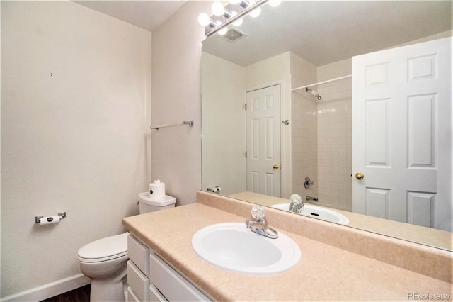 full bathroom featuring vanity, toilet, and tiled shower / bath