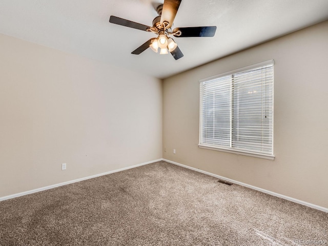 carpeted empty room featuring plenty of natural light and baseboards