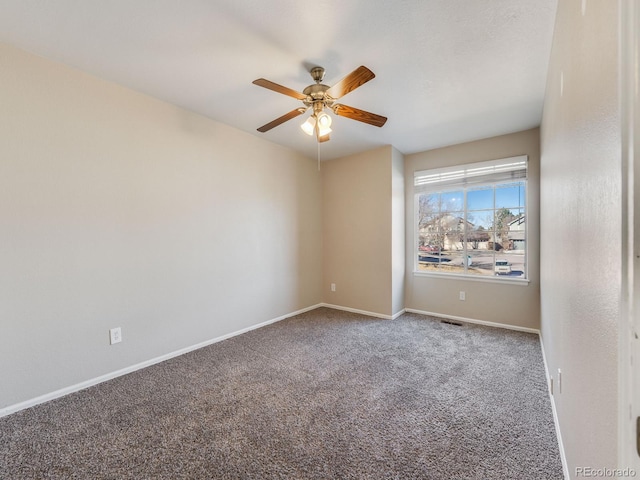 unfurnished room with ceiling fan, visible vents, baseboards, and carpet flooring