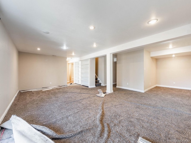 finished basement featuring carpet, stairs, baseboards, and recessed lighting