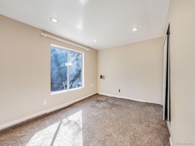 carpeted empty room with recessed lighting and baseboards