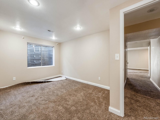 empty room with recessed lighting, carpet flooring, visible vents, and baseboards