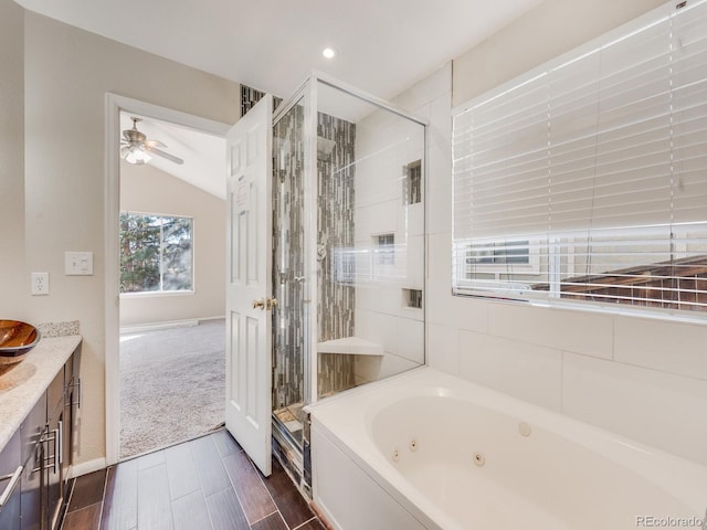 full bath featuring vaulted ceiling, a stall shower, a whirlpool tub, and a ceiling fan