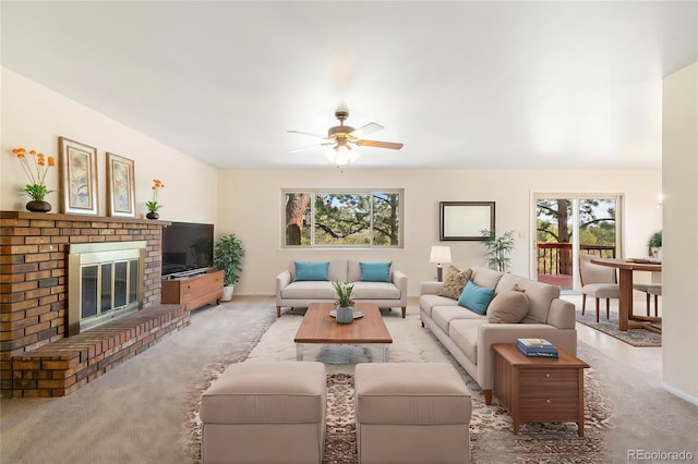 living room with light colored carpet, a brick fireplace, and a ceiling fan