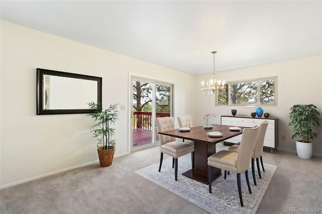 dining room featuring an inviting chandelier, baseboards, and light carpet