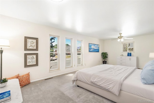 carpeted bedroom featuring baseboards and ceiling fan