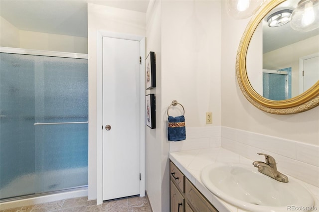 full bath with vanity and a shower stall