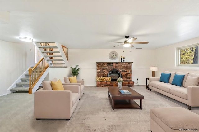 living area featuring stairway, baseboards, a ceiling fan, and carpet floors