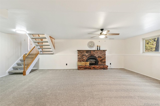 unfurnished living room with carpet flooring, baseboards, ceiling fan, and stairs