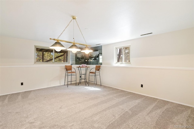 unfurnished dining area with carpet flooring and baseboards