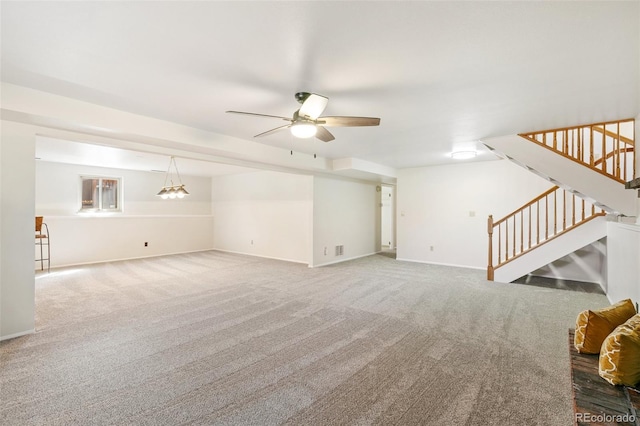 unfurnished living room featuring stairway, baseboards, carpet, and ceiling fan