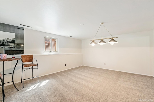 dining space featuring baseboards and carpet floors