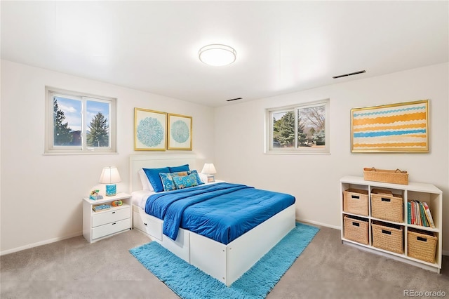 bedroom featuring multiple windows, baseboards, visible vents, and carpet floors