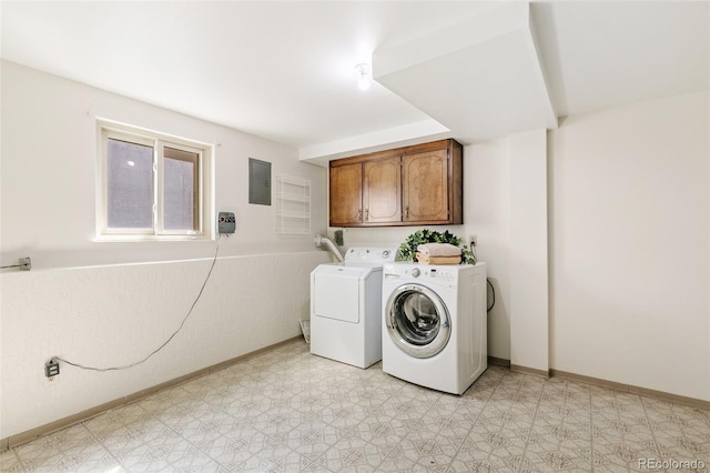 washroom with light floors, baseboards, washing machine and clothes dryer, electric panel, and cabinet space