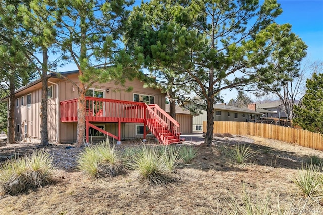 back of house featuring stairway, fence, and a wooden deck