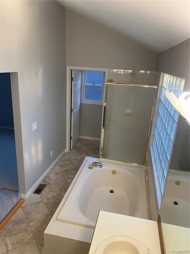 bathroom with lofted ceiling, sink, and separate shower and tub