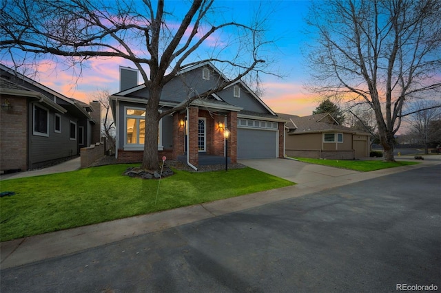 view of front of property featuring driveway, a front lawn, a garage, brick siding, and a chimney