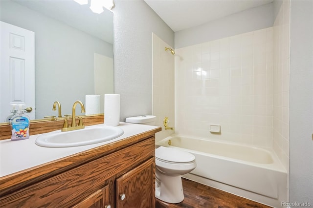 full bath with bathtub / shower combination, vanity, toilet, and wood finished floors