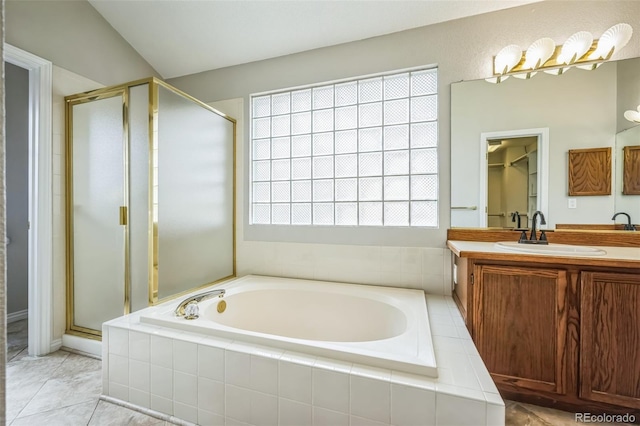 full bathroom with a bath, a stall shower, and vanity