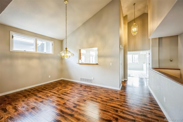 interior space featuring visible vents, baseboards, an inviting chandelier, and dark wood-style flooring