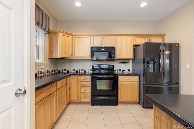 kitchen with light tile patterned flooring and black appliances