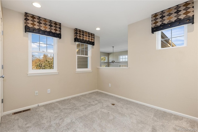 carpeted spare room featuring a healthy amount of sunlight