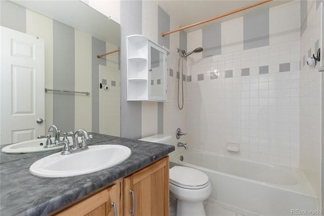 full bathroom with vanity, toilet, and tiled shower / bath combo