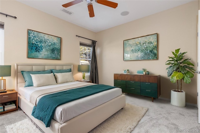 bedroom with light carpet and ceiling fan