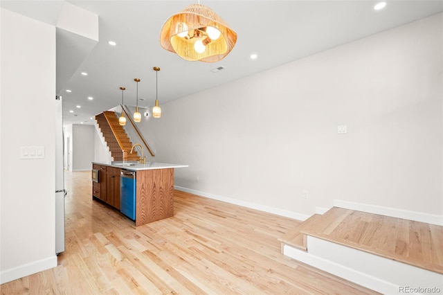 kitchen featuring light wood-style floors, baseboards, open floor plan, and recessed lighting