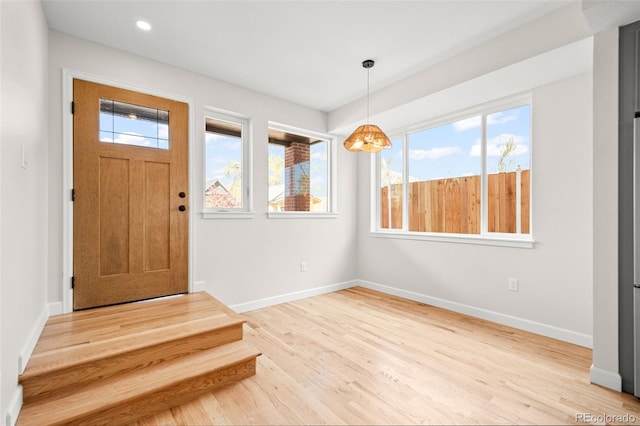 entryway featuring an inviting chandelier, recessed lighting, baseboards, and wood finished floors