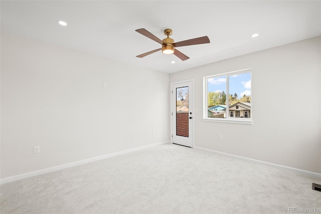 empty room featuring baseboards, ceiling fan, light carpet, and recessed lighting