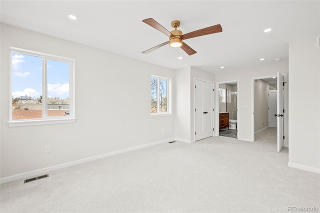 unfurnished bedroom featuring baseboards, recessed lighting, light carpet, and visible vents