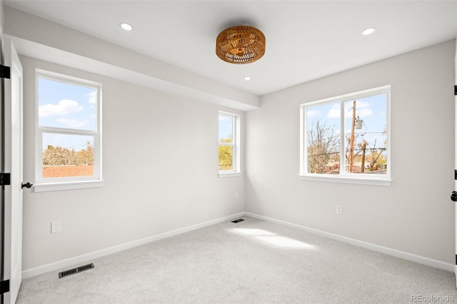 carpeted spare room with baseboards, recessed lighting, and visible vents