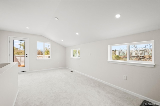 additional living space with baseboards, lofted ceiling, and recessed lighting