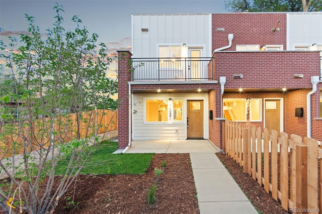 1052 N Knox Ct, Denver, CO 80204 - townhome / multi-family property with a balcony, a fenced backyard, and a patio area