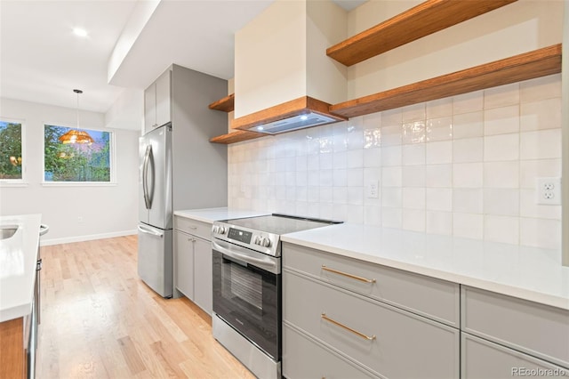 1052 N Knox Ct, Denver, CO 80204 - kitchen featuring open shelves, gray cabinets, stainless steel appliances, premium range hood, and light wood-type flooring