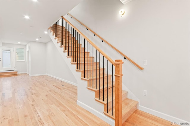 1052 N Knox Ct, Denver, CO 80204 - stairway featuring baseboards, wood finished floors, and recessed lighting