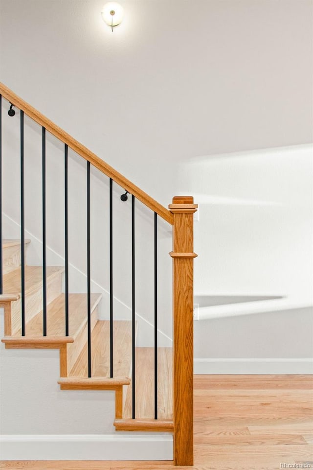 1052 N Knox Ct, Denver, CO 80204 - stairs featuring baseboards and wood finished floors