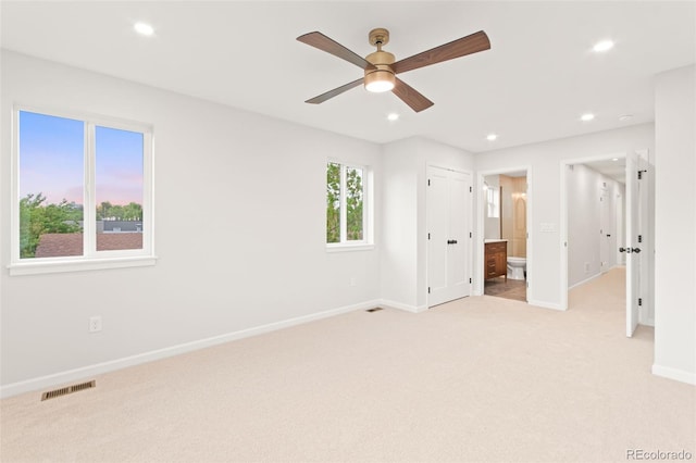 1052 N Knox Ct, Denver, CO 80204 - unfurnished bedroom with light carpet, recessed lighting, baseboards, and ensuite bathroom
