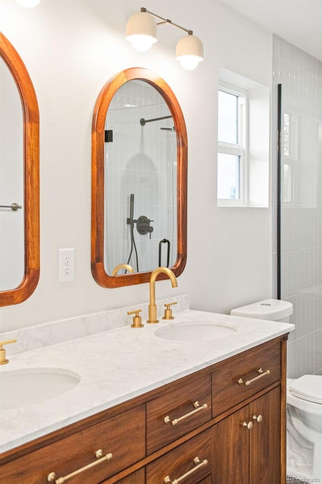 1052 N Knox Ct, Denver, CO 80204 - bathroom with double vanity, toilet, and an enclosed shower