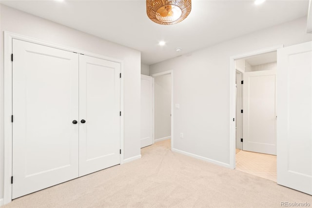1052 N Knox Ct, Denver, CO 80204 - unfurnished bedroom featuring light carpet, baseboards, recessed lighting, and a closet