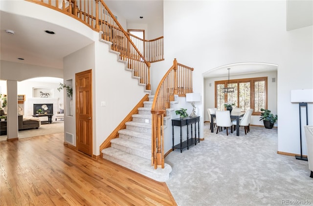 stairway with carpet flooring and a high ceiling