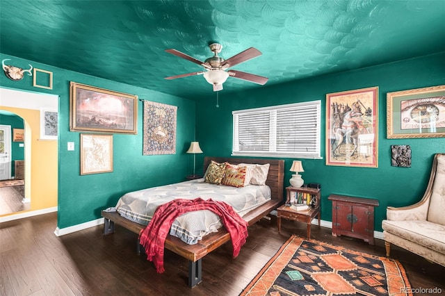 3202 S Dahlia St, Denver, CO 80222 - bedroom featuring baseboards, wood finished floors, arched walkways, and a ceiling fan