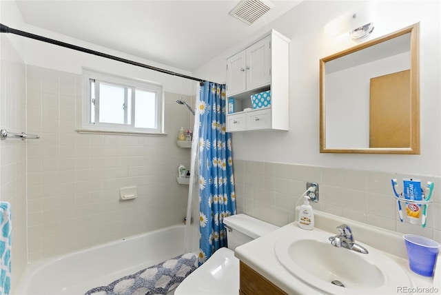 4505 W Gill Pl, Denver, CO 80219 - bathroom featuring shower / tub combo with curtain, tile walls, and vanity