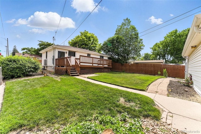 4505 W Gill Pl, Denver, CO 80219 - fenced backyard featuring a wooden deck