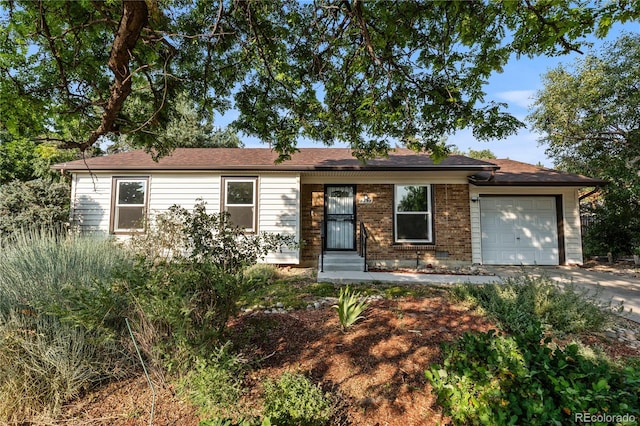 2452 S Kittredge Way, Aurora, CO 80013 - ranch-style house with an attached garage, concrete driveway, and brick siding