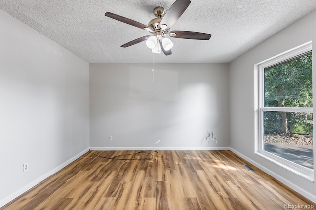 2452 S Kittredge Way, Aurora, CO 80013 - spare room featuring a textured ceiling, wood finished floors, and ceiling fan